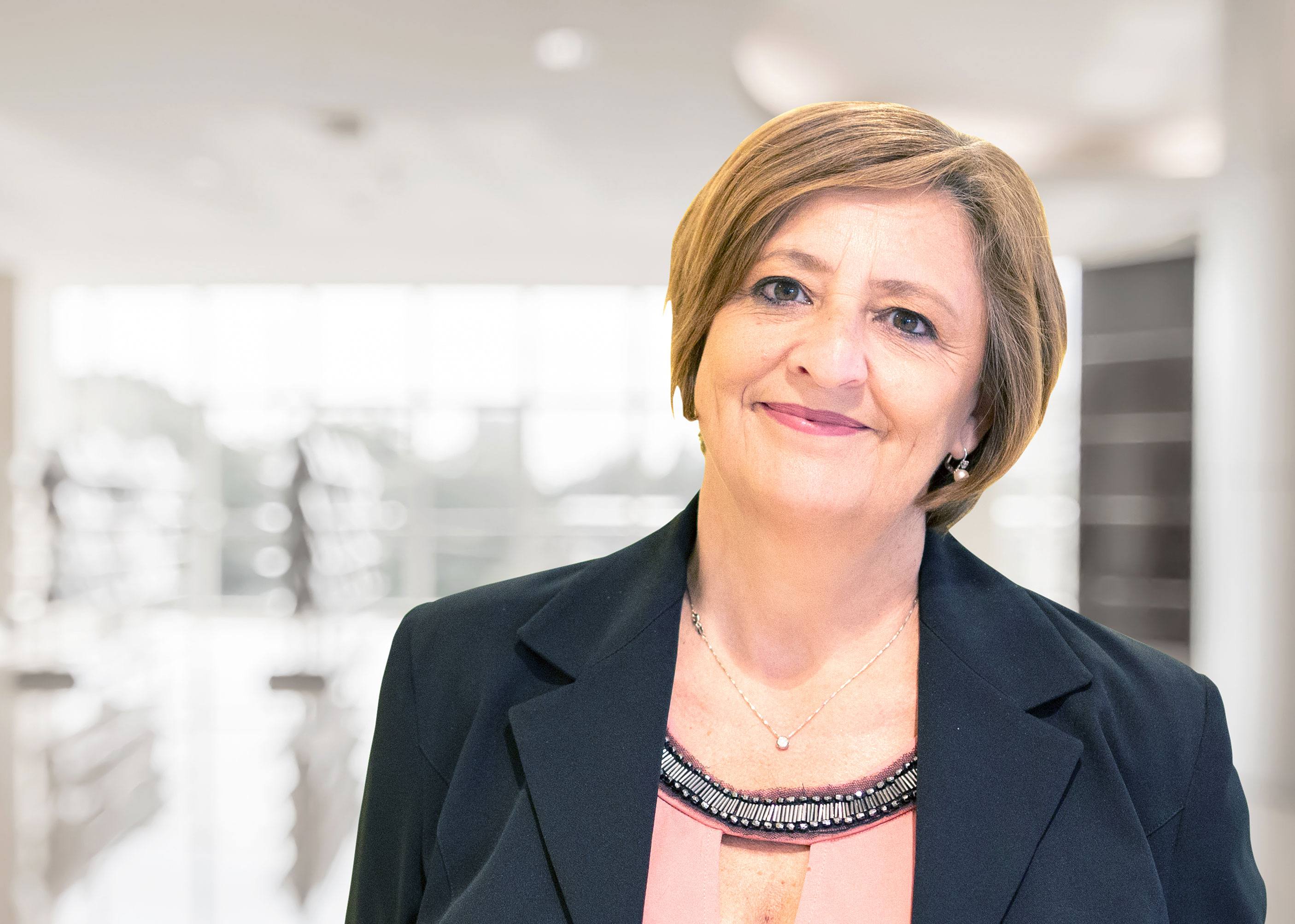 Middle-aged woman with short hair smiling at the camera.